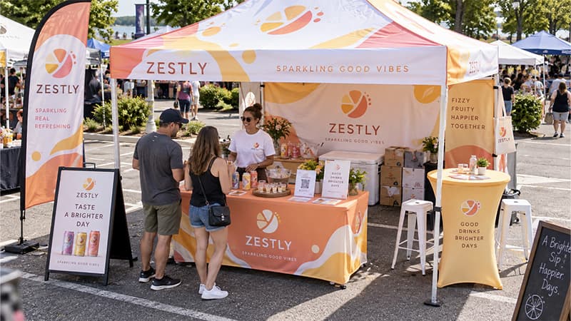 10×10 vendor booth with a front display counter, product area, and open space for visitors to enter and interact.