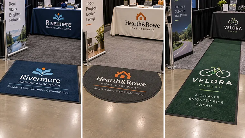 Branded floor mats marking the entrance to three compact trade show booths