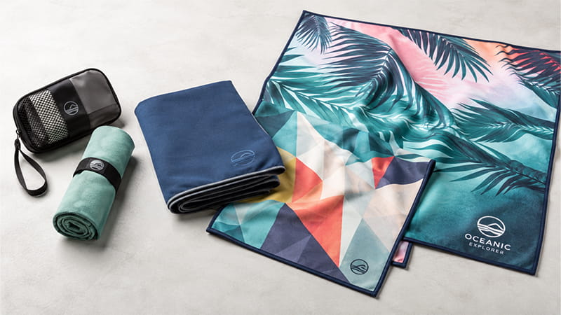 Compact microfiber towels in printed and solid designs with a travel pouch