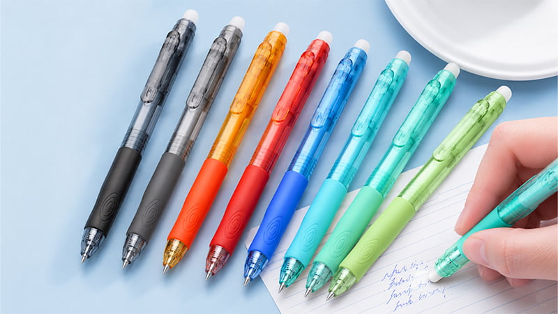 A hand erasing handwritten notes with the tip of an erasable pen